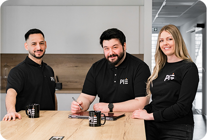 PIE Marketing Team am Tisch mit PIE-Tassen, wie sie Kontaktaufnahme zur Werbeagentur besprechen