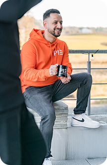 PIE Marketing Agentur Bodensee Teammitglied mit PIE Tasse in der Hand